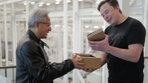 Elon Musk receiving a DGX Spark AI computer from Jensen Huang at SpaceX’s Starbase.