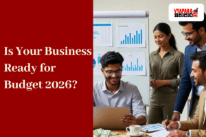 Budget | A group of young Sri Lankan entrepreneurs discussing financial charts and budget reports in a modern office. A man seated at a desk works on a laptop while others stand nearby, smiling and analysing graphs on a board. The text “Is Your Business Ready for Budget 2026?” appears on a red background beside the Vyapara.lk logo.