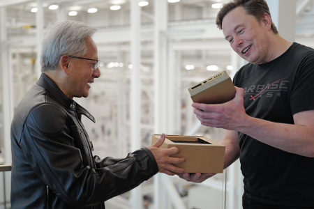 Elon Musk receiving a DGX Spark AI computer from Jensen Huang at SpaceX’s Starbase.